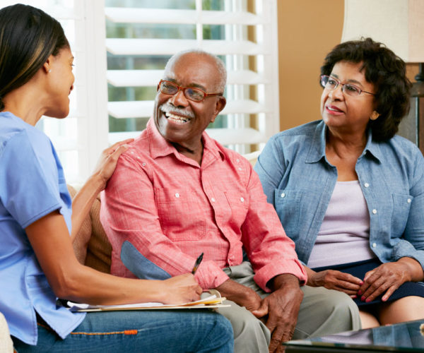 A couple having a conversation with a nurse