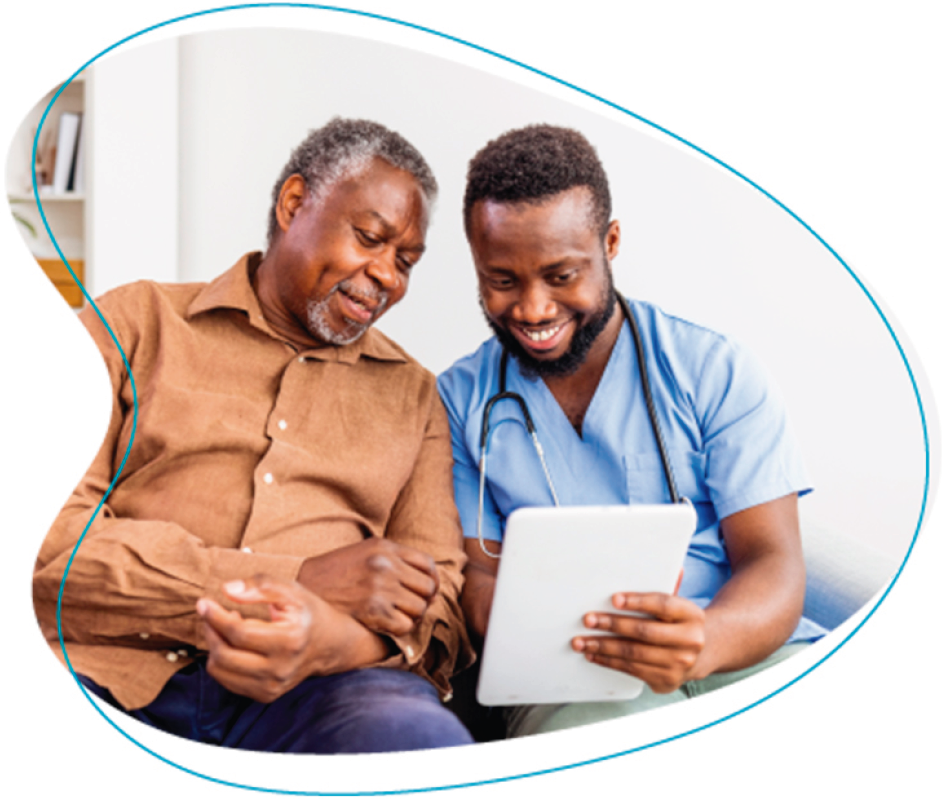 Young doctor is meeting with an older male patient and they are viewing a tablet.